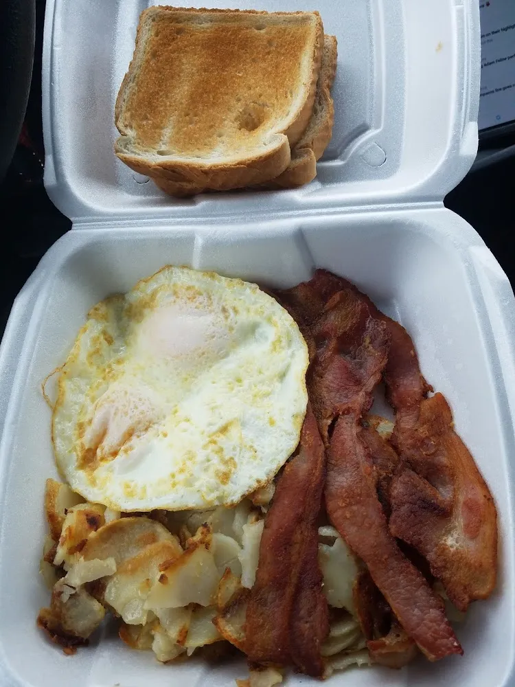 Eggs over Medium with Hash Browns Bacon and White Toast